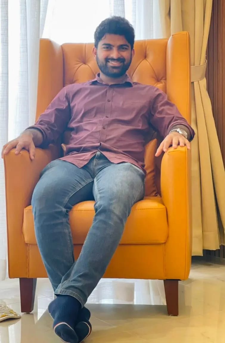 Man in a red shirt sitting in a sofa